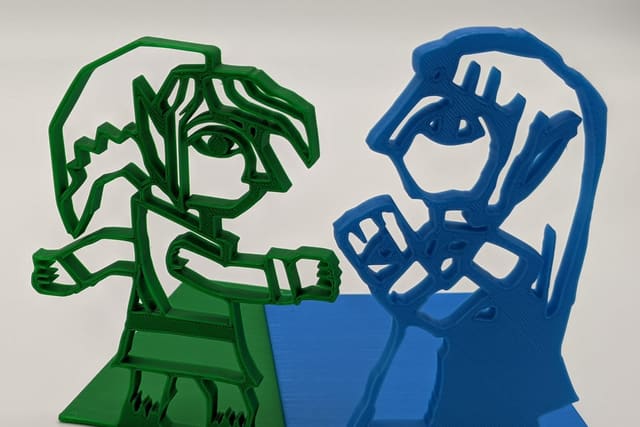 3D-printed bookends: green Link mid-swing and blue Princess Zelda, from The Legend of Zelda